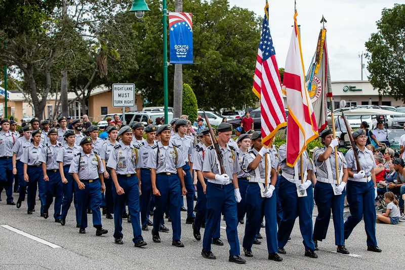 Uniformed cadets carrying flags march in the Cape Coral Veterans Day Parade
