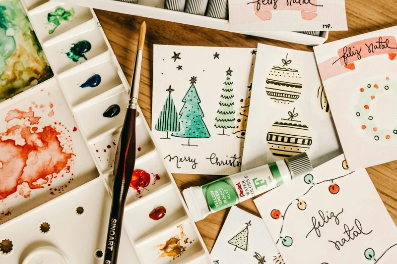 Hand-painted watercolor holiday cards with Christmas trees and ornaments
