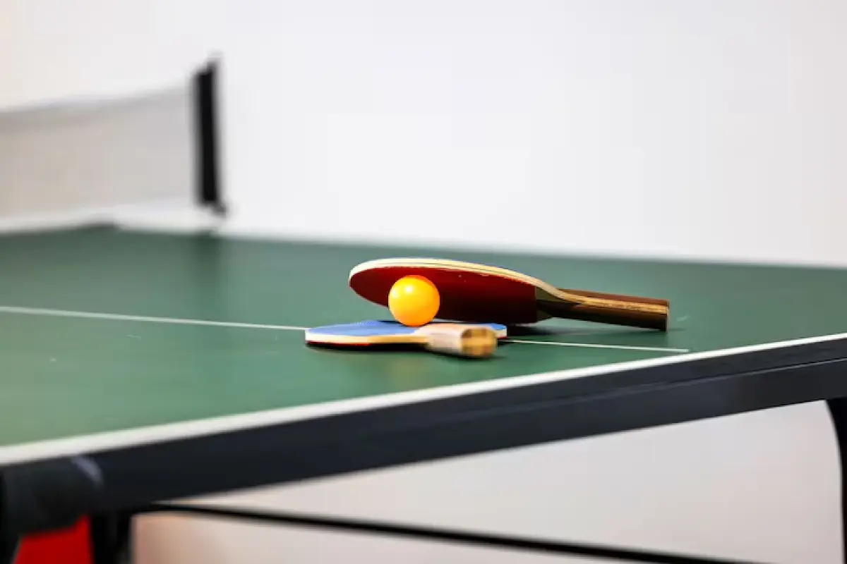 Ping-pong paddles and ball on the game room table
