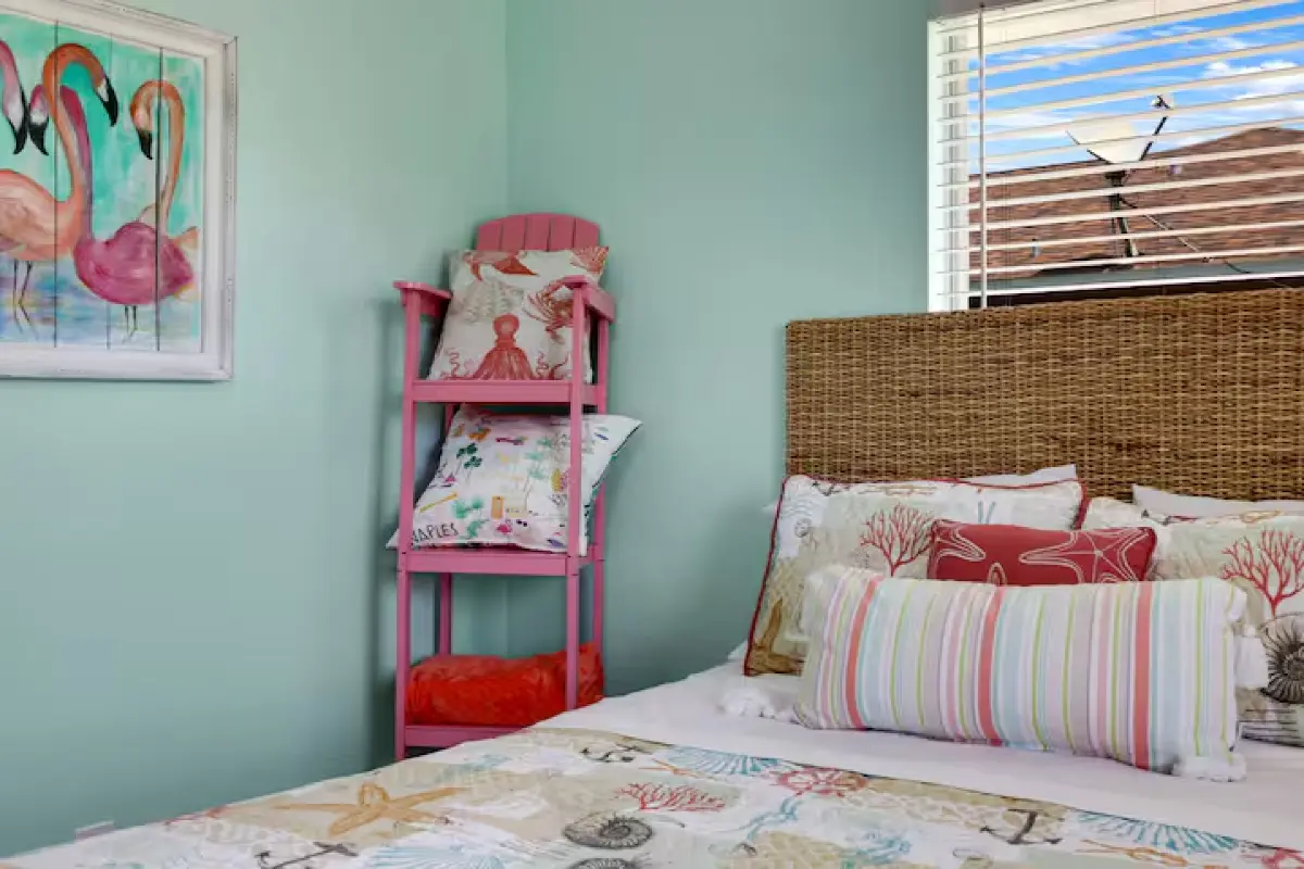 Bedroom with colorful headboard and shelves