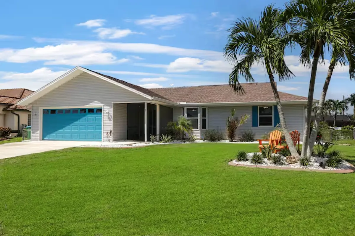 Front of the Beachy Keen home with driveway parking and lawn