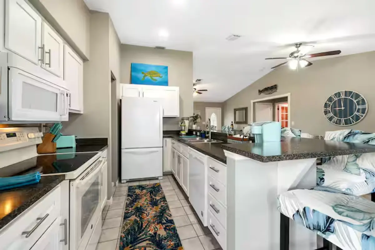 Fully equipped kitchen with white cabinets